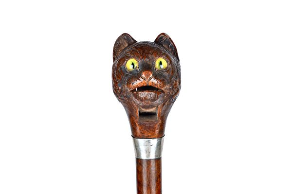 A Black Forest novelty walking cane, late 19th century, the carved cat's head pommel with automated jaw over glass eyes, white metal collar and hardwo