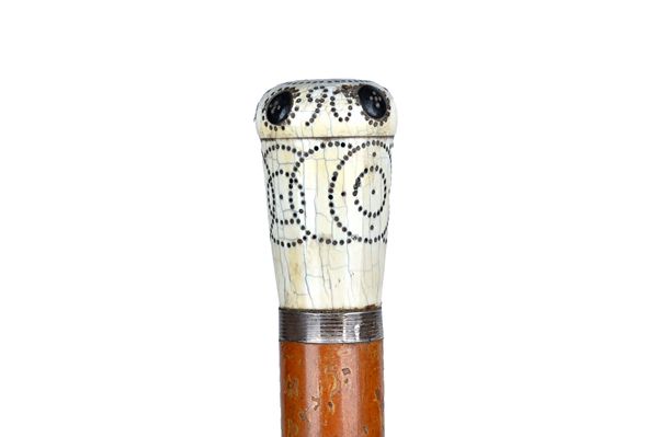 A silver pique inlaid ivory and malacca walking cane, dated 1690, initialled 'T.R', with four applied pique buttons, 84.5cm. Illustrated