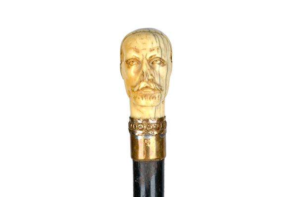 An ivory and ebonised walking cane, the pommel 18th century, carved as a Turk's head, 84.5cm. Illustrated