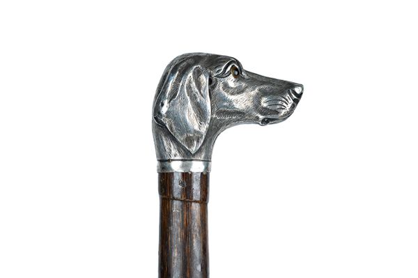 A silver mounted bamboo walking cane, the handle cast as a dog's head with inset glass eyes, hallmarked London 1889, 86cm. Illustrated