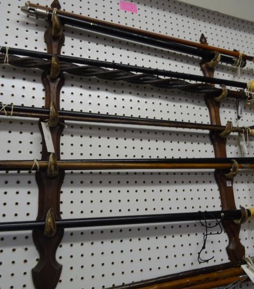 A French oak and boar tusk mounted walking stick/gun rack, early 20th century, of shaped Gothic form (84cm high) and three pairs of wooden ten tier wa