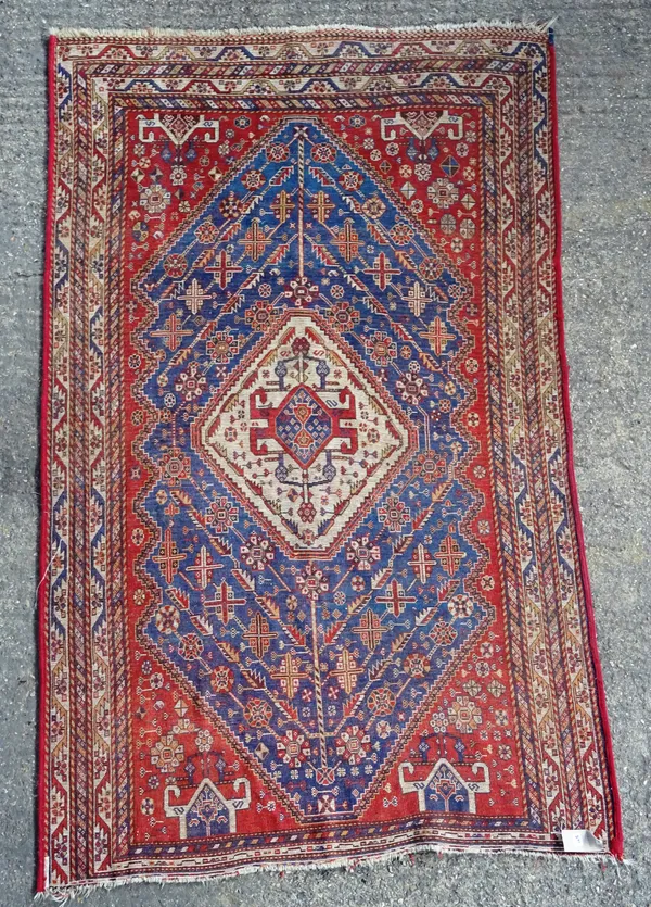 A North West Persian rug, the central white medallion with stepped Kazak style motif, similar spandrels, deep blue field, 246cm x 148cm.