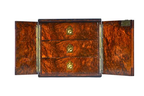 A Victorian figured walnut table top collector's cabinet, the pair of doors enclosing three drawers, with Bramah lock, (key lacking) 31cm wide x 28cm
