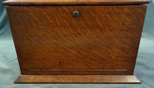 'Army & Navy CSI Makers'; an early 20th century oak travelling writing box, the lift top and fold-out front revealing a fitted interior, with Bramah l