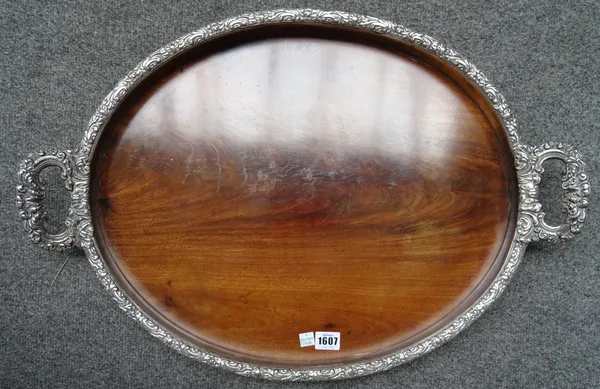 A George III mahogany oval serving tray, in a foliate chased silver plated frame, 64cm wide x 44cm deep.