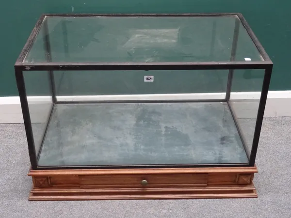 A large table top display case, the metal bound rectangular glazed top on an oak single drawer plinth base, 91cm wide x 58cm high x 55cm deep.