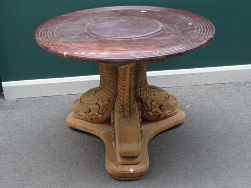 A French gueridon, the channelled marble circular top on a stripped pine base of three opposing serpents, 96cm diameter x 73cm high.