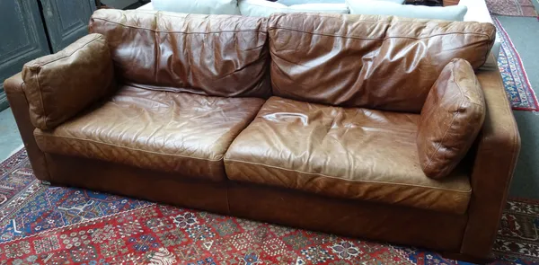 A 20th century brown leather upholstered square back sofa on block supports, 224cm wide x 71cm high.