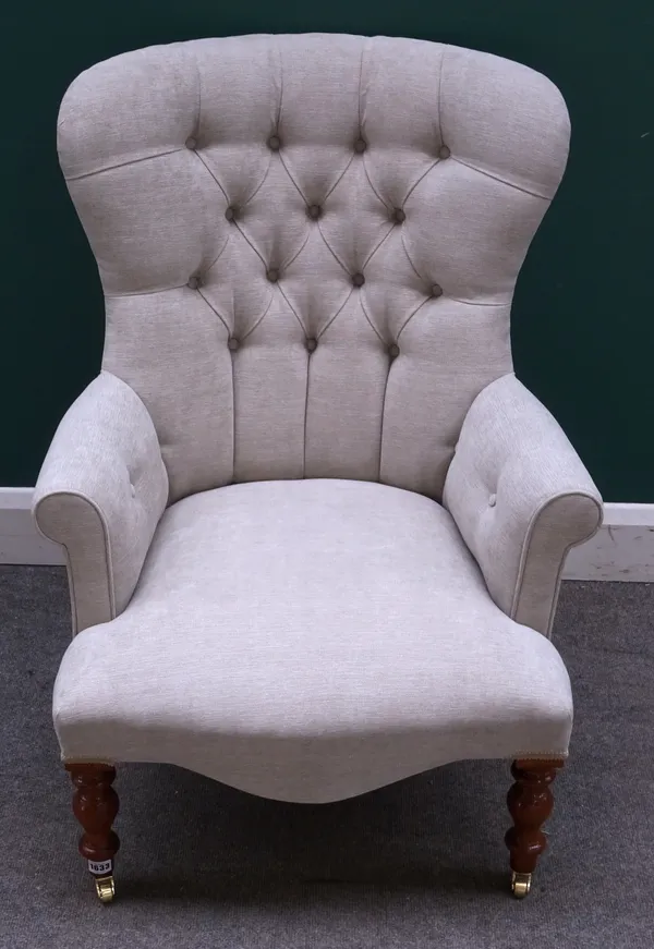 A Victorian style grey upholstered button back armchair on baluster turned supports, 68cm wide x 90cm high.