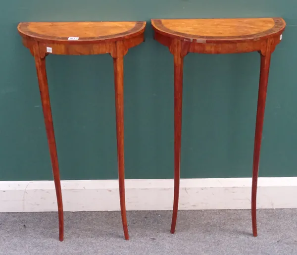 A pair of late 18th/ early 19th century Continental satinwood and fruitwood demi-lune console tables, each on splayed turned supports, 45cm wide x 82c