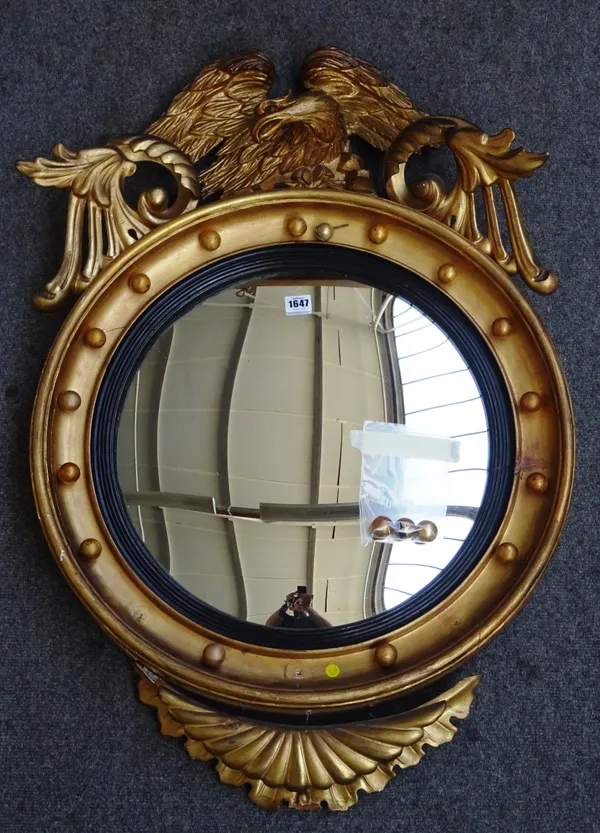 A Victorian gilt framed convex wall mirror with eagle surmount, 63cm wide x 92cm high.