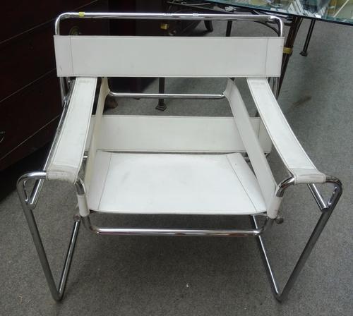 After Marcel Breuer; a pair of Wassily model No B3 easy armchairs, upholstered in cream leather, 78cm wide x 74cm high.