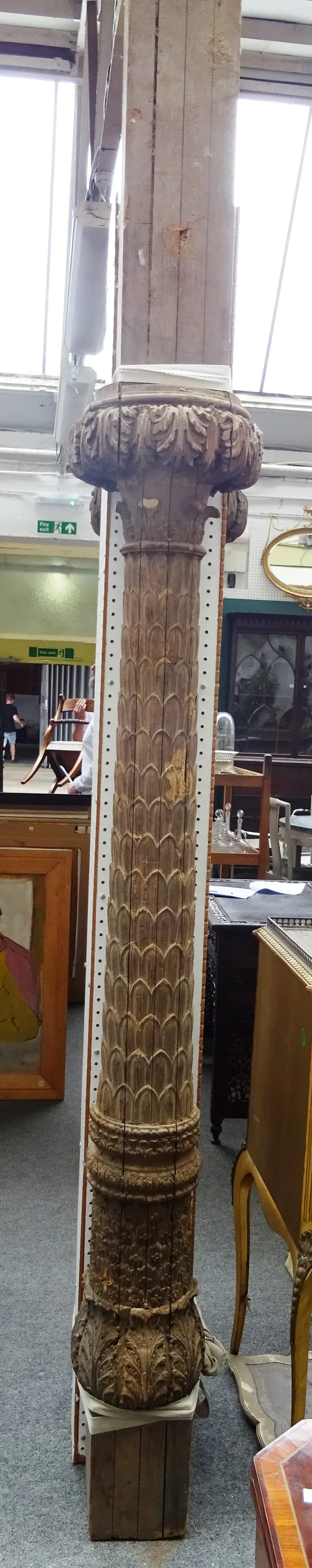 A pair of 19th century carved hardwood columns, each with acanthus scroll top and scaled carved column, 280cm high, (2).