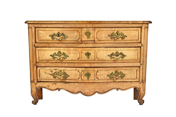 A Louis XV bleached oak commode of two short and two long serpentine drawers on squat scroll supports, 133cm wide x 77cm high x 69cm deep. Illustrated