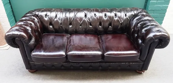 A 20th century brown leather button upholstered Chesterfield sofa, with rollover arms, 195cm wide x 95cm deep x 75cm high.
