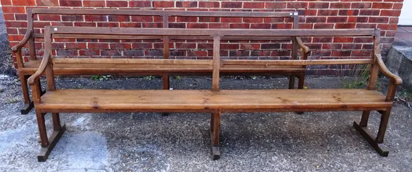 A pair of 19th century French oak and pine open back and arm benches on chamfered block supports, 250cm wide x 86cm high (2).