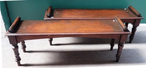 A pair of 19th century mahogany hall benches with turned end stops on baluster supports, 137cm wide x 53cm high x 35cm deep (2).
