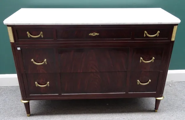 A Louis XVI style commode, the white marble top over a gilt metal mounted mahogany three drawer base, on tapering turned supports, 124cm wide x 86cm h