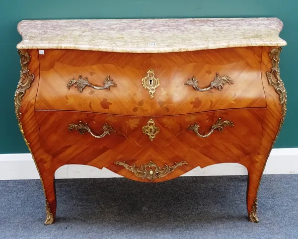 A Louis XV style commode, the serpentine marble top over a gilt metal mounted floral marquetry inlaid kingwood bombé two drawer base, on splayed suppo