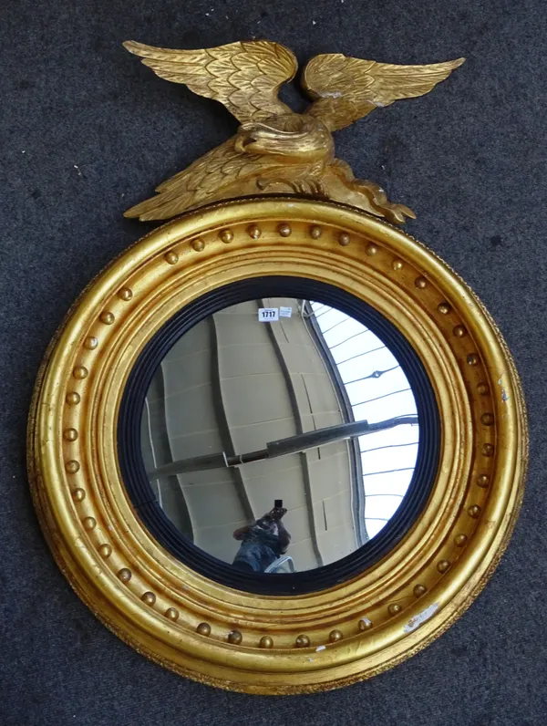A Victorian gilt framed convex mirror with eagle surmount, 80cm wide x 108cm high.