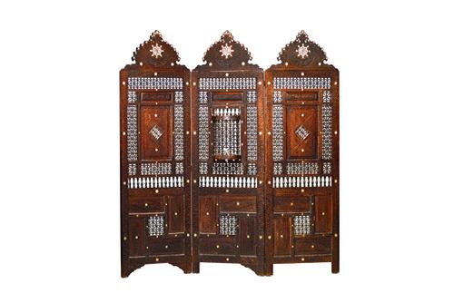 A late 19th North African mother-of-pearl inlaid carved hardwood and bobbin turned three fold screen with integral small door, 180cm wide x 192cm high