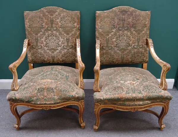A pair of mid-18th century style gold painted open arm chairs with serpentine seat and scroll supports, 70cm wide x 107cm high (2).