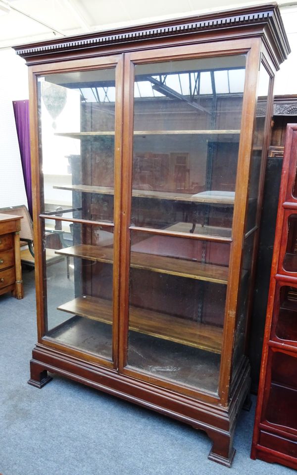 A 19th century mahogany museum display cabinet, the dentil cornice over a pair of glazed doors and sides on bracket feet. 146cm wide x 218cm high x 63