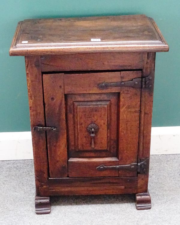 A French 17th century oak cupboard with single raised panel door on sleigh feet, 55cm wide x 72cm high x 33cm deep.