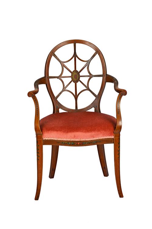 Maple & Co; a polychrome painted satinwood 'spider web' back open armchair on splayed supports, 63cm wide x 94cm high. Illustrated
