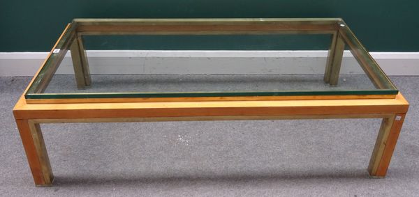 A mid-20th century lacquered brass and beech rectangular coffee table, on block supports, 75cm wide x 37cm high x 140cm long.