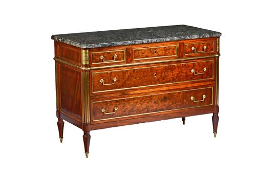 A Louis XVI style commode circa 1900, the rectangular marble top over a gilt metal mounted mahogany base of three short and two long drawers flanked b