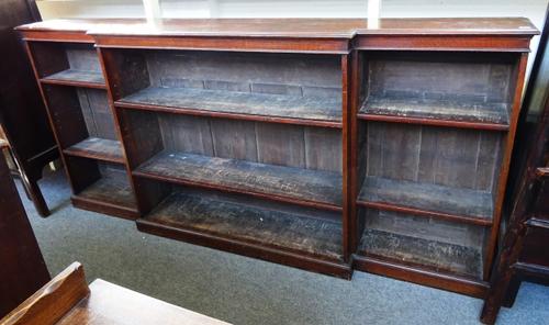 A 19th century oak floor standing breakfront open bookcase on a plinth base, 246cm wide x 115cm high x 36cm deep.