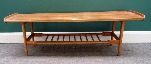 A 20th century design laminated teak and beech rectangular coffee table, with upswept ends and slatted undertier, 132cm wide x 42cm high x 40cm deep.P