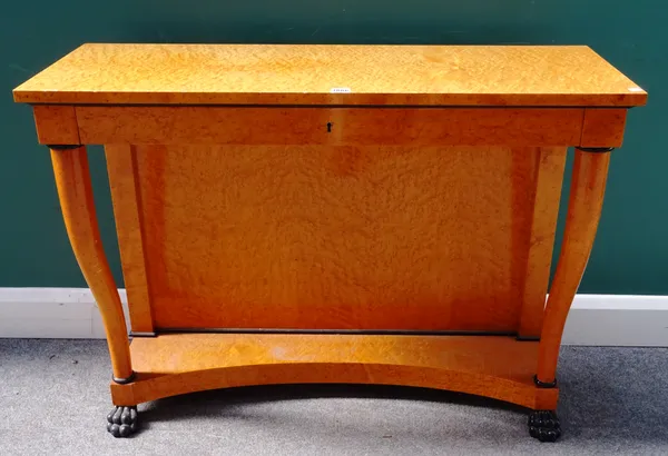 A Biedermeier style part ebonised bird's eye maple single drawer console, on turned supports and paw feet, 104cm wide x 81cm high x 36cm deep.