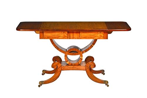 A pair of late George III style hardwood sofa tables each with flush fit frieze drawers on open column and four downswept supports. 88cm across x 141c
