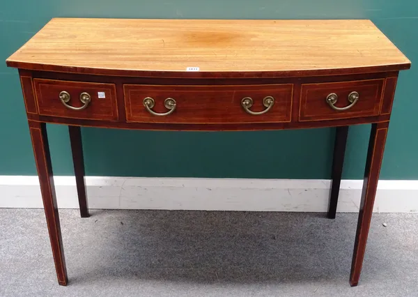 A George III inlaid mahogany bowfront three drawer writing table on tapering square supports, 107cm wide x 79cm high x 52cm deep.