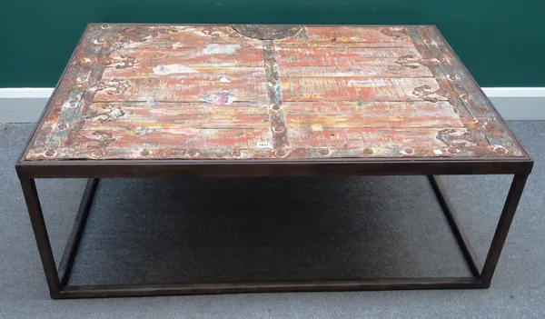 A metal framed rectangular coffee table with inset reclaimed Eastern iron bound door, 82cm x 122cm long x 45cm high.