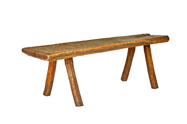 A rustic oak slaughter table, probably French late 18th/early 19th century, the shaped rectangular single slab top with perimeter blood gathering chan