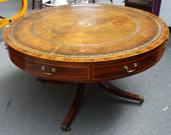 A George III style mahogany drum table with four true and four dummy drawers on four downswept supports, 134cm diameter x 79cm high.