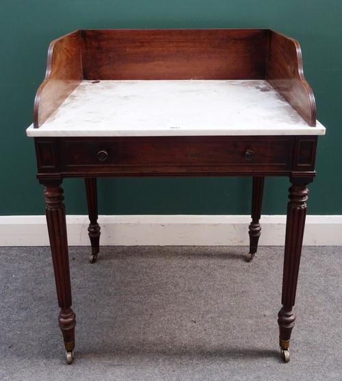 Attributed to Gillows; a Regency mahogany wash stand with three-quarter galleried marble top over dummy drawers on tapering reeded supports, 77cm wide