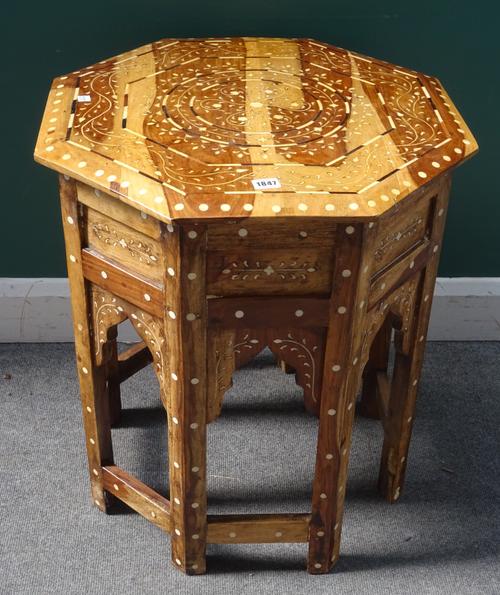 A 20th century bone inlaid North African hardwood octagonal occasional table with Islamic arched frieze, 62cm wide x 67cm high.