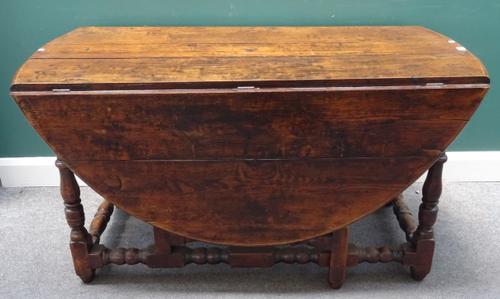 A 17th century style oak gate leg dining table, on block and turned supports, 65cm across x 166cm across open x 140cm wide x 76cm high.