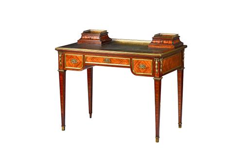 A French late 19th century gilt brass mounted tulipwood writing table in the Louis XVI style, the rectangular top with pair of short drawers over thre