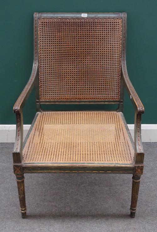 A George III style parcel gilt green painted open arm library bergère, on tapering fluted supports, 63cm wide x 94cm high.Provenance; Property from Pr