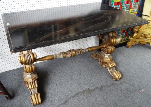 A Victorian centre table, the later faux marble top on a pair of gilt and silver painted cartouche trestle end standards, 130cm wide x 80cm high x 87c
