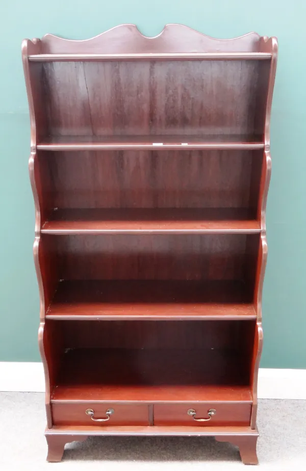 A Regency style mahogany floor standing five tier waterfall bookcase with single drawer base, 77cm wide x 152cm high x 40cm deep.