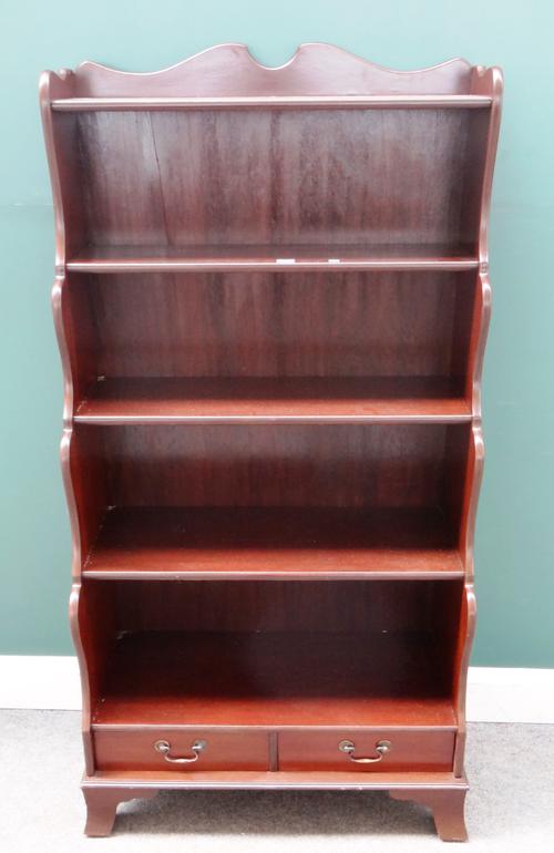 A Regency style mahogany floor standing five tier waterfall bookcase with single drawer base, 77cm wide x 152cm high x 40cm deep.