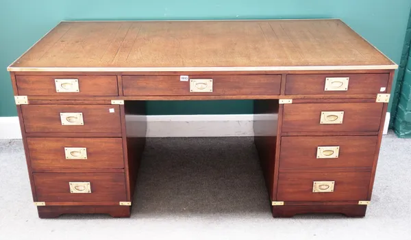 A campaign style brass bound hardwood pedestal desk with nine drawers about the knee on bracket feet, 154cm wide x 75cm high x 77cm deep.