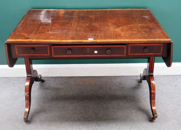 A Regency crossbanded rosewood sofa table, with three frieze drawers and dummy opposing on four downswept supports, 115cm cross x 157cm across open x