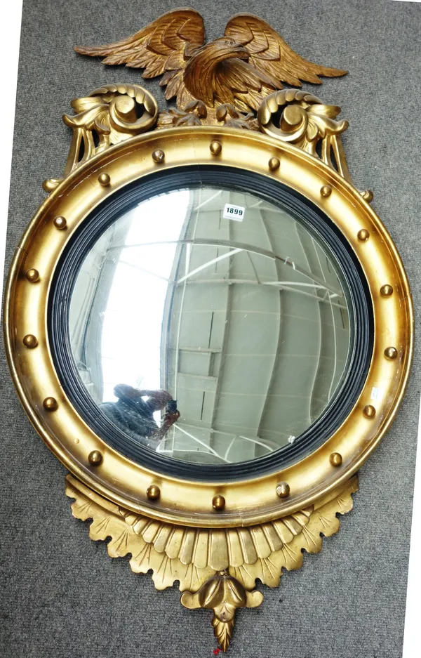 A Victorian gilt framed circular convex mirror with eagle surmount, 62cm wide x 105cm high, together with a rosewood framed William IV footstool on tr